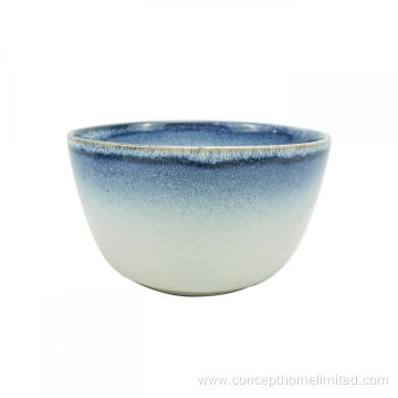 Reactive glazed stoneware dinner set with blue rim